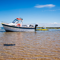 Buy canvas prints of White boat on sand by youri Mahieu