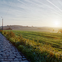 Buy canvas prints of paving sett roadin autumnal sunlight by youri Mahieu