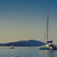 Buy canvas prints of                      A white yacht moored off Paxo by Mike Dale