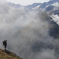 Buy canvas prints of Hiker in France alps standing on edge of mountain  by Dalius Baranauskas
