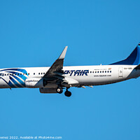 Buy canvas prints of Boeing 737-800 passenger aircraft of the airline Egyptair flying before landing against sky by Juan Jimenez