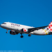 Buy canvas prints of Airbus A320 passenger aircraft of the airline Volotea flying before landing against sky by Juan Jimenez