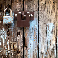Buy canvas prints of Two locks on old wooden garage door, peeling paint by Robert Pastryk