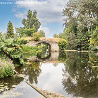 Buy canvas prints of Grounds of Warkworth Castle on the river with a arch and flowing water  by Holly Burgess