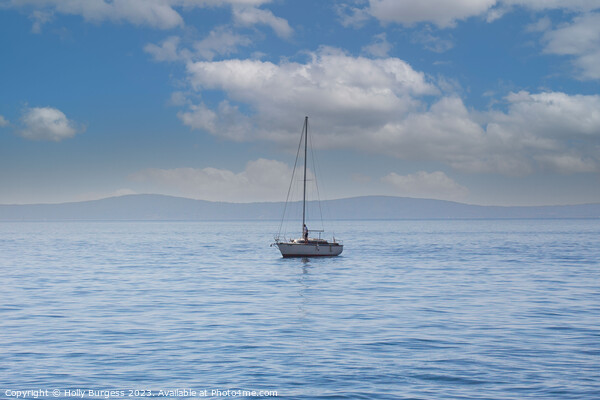 One lonely yacht on the carm sea of Split, a town in Crosia, mountions in the back ground  Picture Board by Holly Burgess
