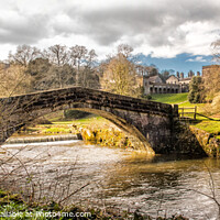 Buy canvas prints of Ilam Ground with Bridge and Hall in the back ground  by Holly Burgess