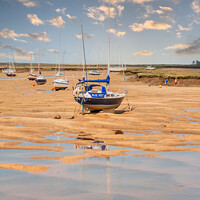 Buy canvas prints of Hunstanton Beach: Reflections and Anchored Vessels by Holly Burgess