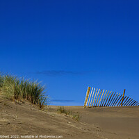 Buy canvas prints of Fence on sand dune at Barmouth beach, Gwynedd by Jenny Hibbert