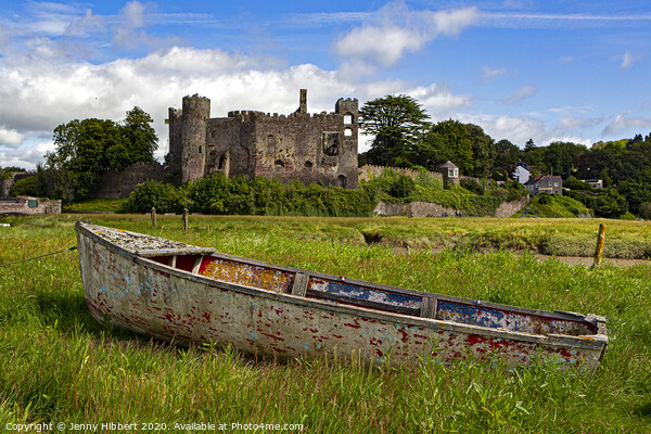 Laugharne Castle with an abandoned boat in the foreground Picture Board by Jenny Hibbert