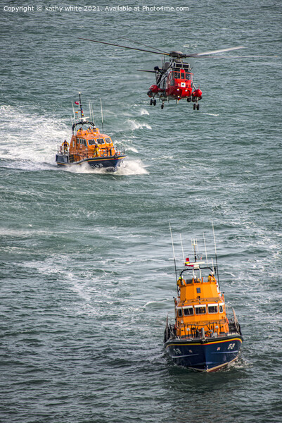 Lifeboats with the rescue helicopter on stormy sea Picture Board by kathy white