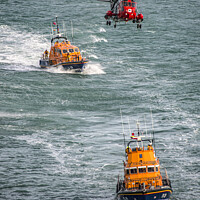 Buy canvas prints of Lifeboats with the rescue helicopter on stormy sea by kathy white