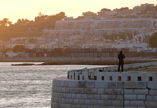 Silhouette of a man standing at the coast of Lisbon Picture Board by Lensw0rld 