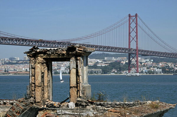 Coastal view in Lisbon, Portugal, with bridge and boat Picture Board by Lensw0rld 