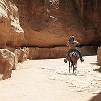 Buy canvas prints of A Bedouin riding in the siq in Petra by Lensw0rld 
