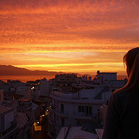 Buy canvas prints of Girl watching the sunset in Heraklion, Crete, Gree by Lensw0rld 