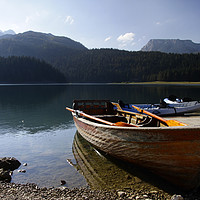 Buy canvas prints of Boats on Black Lake, Montenegro by Lensw0rld 