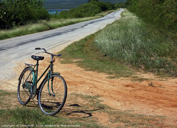 Retro bike next to an empty road in Cuba Picture Board by Lensw0rld 