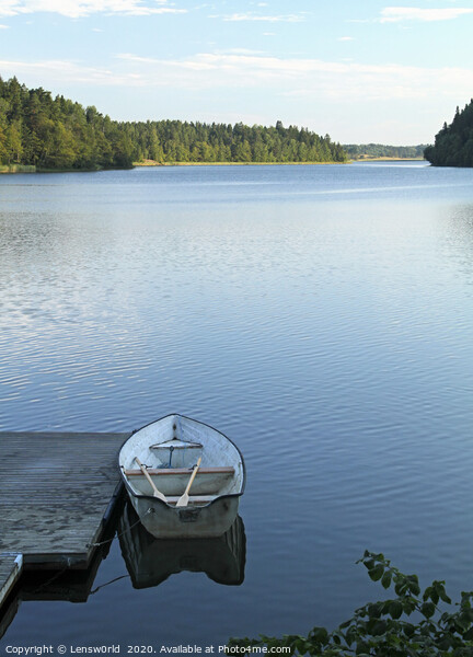 Calm lake with rowboat in Sweden Picture Board by Lensw0rld 