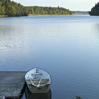 Buy canvas prints of Calm lake with rowboat in Sweden by Lensw0rld 