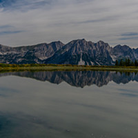 Buy canvas prints of Reflections of the Wilder Kaiser by Andrew McConochie