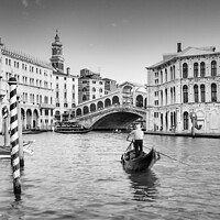 Buy canvas prints of Gondolier at the Rialto bridge, Grand Canal, Venic by Justin Foulkes