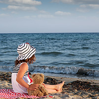 Buy canvas prints of little girl with teddy bear sitting on beach by goce risteski