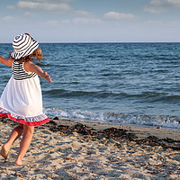 Buy canvas prints of happy little girl running on beach by goce risteski