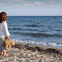 Buy canvas prints of little girl with teddy bear standing on beach and  by goce risteski