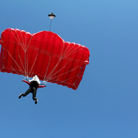 Buy canvas prints of parachutist with red parachute on blue sky by goce risteski