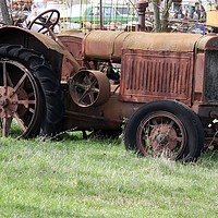 Buy canvas prints of old rusty tractor on field by goce risteski
