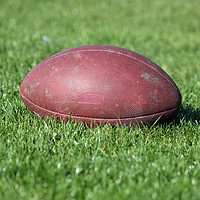 Buy canvas prints of old American football ball on green grass by goce risteski