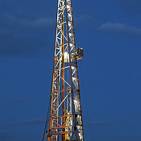 Buy canvas prints of illuminated oil drilling rig on oilfield by goce risteski