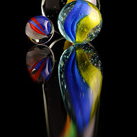 Buy canvas prints of Three colourfull marbles reflecting by Tony Claes
