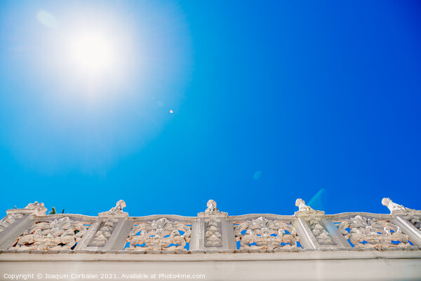 Old style stone balustrade, bottom view with blue sky background Picture Board by Joaquin Corbalan