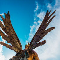 Buy canvas prints of A sculpture of an angel, rear view of its wings against the sky. by Joaquin Corbalan