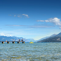 Buy canvas prints of Calm water lake in Garda, Italy with a wooden walkway on a sunny by Joaquin Corbalan
