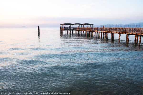 A beautiful sunset on Lago di Garda near the wooden jetty. Picture Board by Joaquin Corbalan