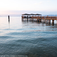 Buy canvas prints of A beautiful sunset on Lago di Garda near the wooden jetty. by Joaquin Corbalan