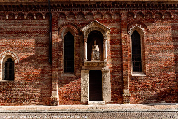 Brick facade in the afternoon sun of a religious Veronese hermit Picture Board by Joaquin Corbalan