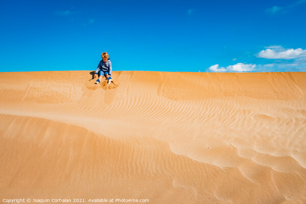 A child played on the sand dunes having fun with freedom, negati Picture Board by Joaquin Corbalan