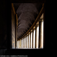 Buy canvas prints of Hallway with monumental columns framed by the dark shadows of a  by Joaquin Corbalan