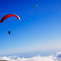 Buy canvas prints of Athletes use an ultralight flexible glider, paraglider, to fly a by Joaquin Corbalan
