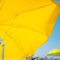 Buy canvas prints of Beach holiday background, with a large yellow umbrella in the fo by Joaquin Corbalan