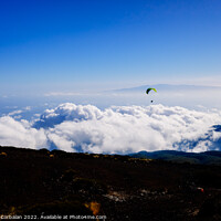 Buy canvas prints of Paragliding above mountain peaks and white clouds during winter  by Joaquin Corbalan