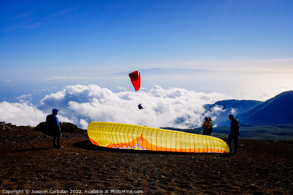 Skydiving experts and monitors prepare the sail of a paraglider  Picture Board by Joaquin Corbalan