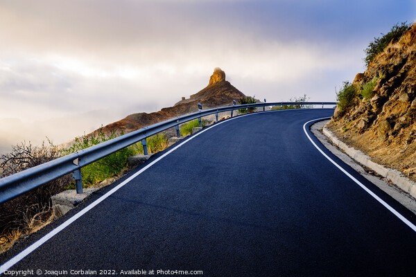 A mountain road approaches the famous Roque Bentayga through the Picture Board by Joaquin Corbalan