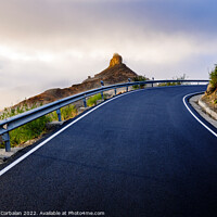 Buy canvas prints of A mountain road approaches the famous Roque Bentayga through the by Joaquin Corbalan