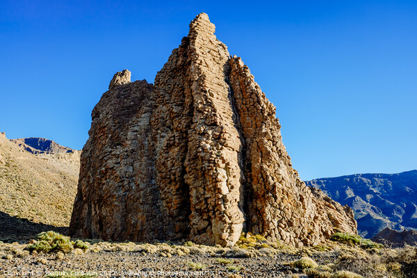 vertical rock stone formations on a bright sky sunny day Picture Board by Joaquin Corbalan