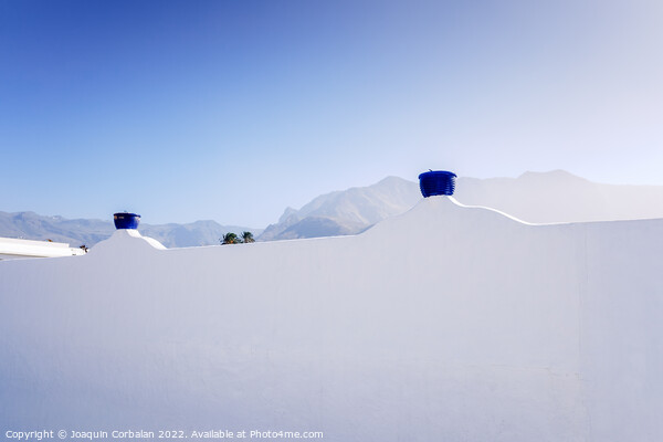 A sunny day to see the mountains behind the whitewashed wall of  Picture Board by Joaquin Corbalan