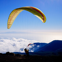 Buy canvas prints of Skydiving experts and monitors prepare the sail of a paraglider  by Joaquin Corbalan